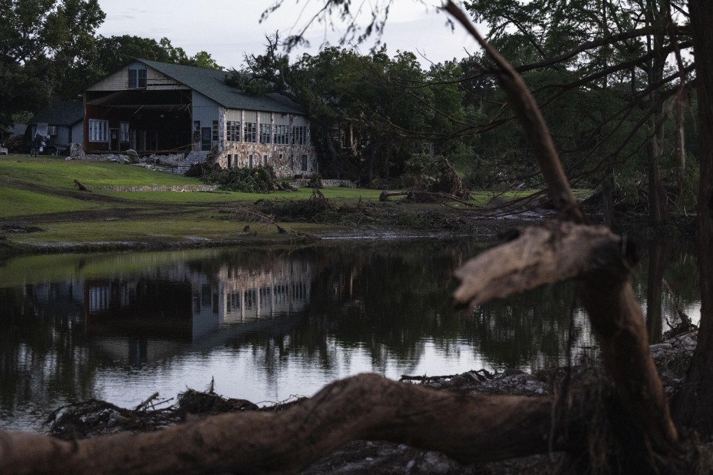 A building at Camp Mystic is reflected in water after a flash flood swept through the area July 7, in Hunt, Texas. Photo: AP