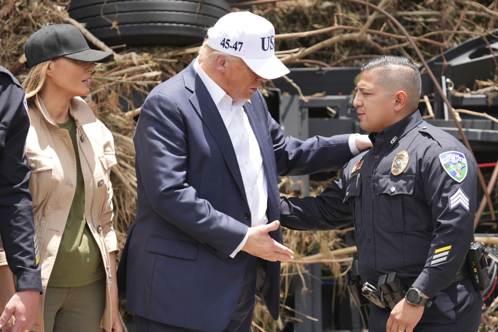 US President Donald Trump and first lady Melania Trump greet a police officer as they observe flood damage in Kerrville, Texas, on Friday. Photo: AP