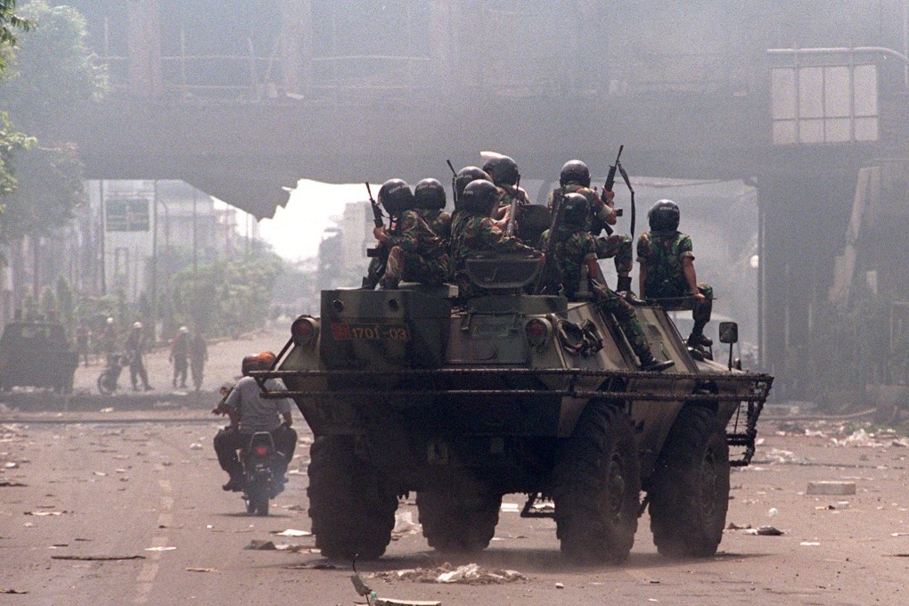 Indonesian troops patrol around damaged sites following the May 1998 riots in Jakarta. Photo: AFP