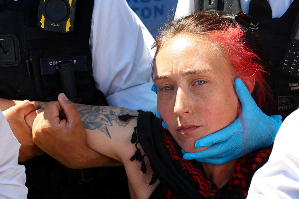 Police officers detain a protester during a demonstration in London on Saturday. Photo: Reuters
