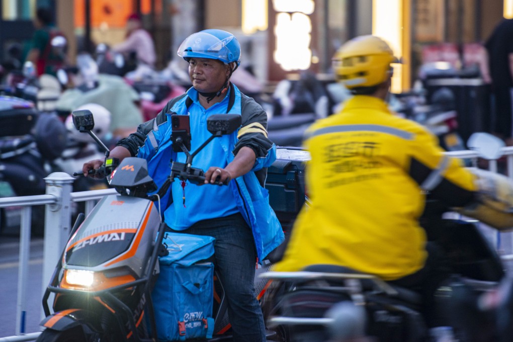 Delivery workers for Ele.me and Meituan pass on a street in Yancheng, in China’s eastern Jiangsu province, on May 14, 2025. Photo: VCG via Getty Images