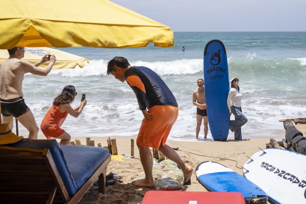 Tourists wander at Kuta Beach in Bali, Indonesia, Photo: EPA-EFE