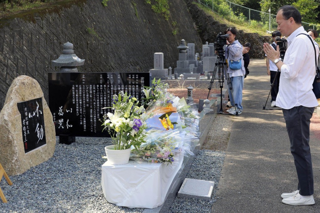 A man prays at a stone monument dedicated to former Japanese prime minister Shinzo Abe in a cemetery in Nara. Photo: Kyodo