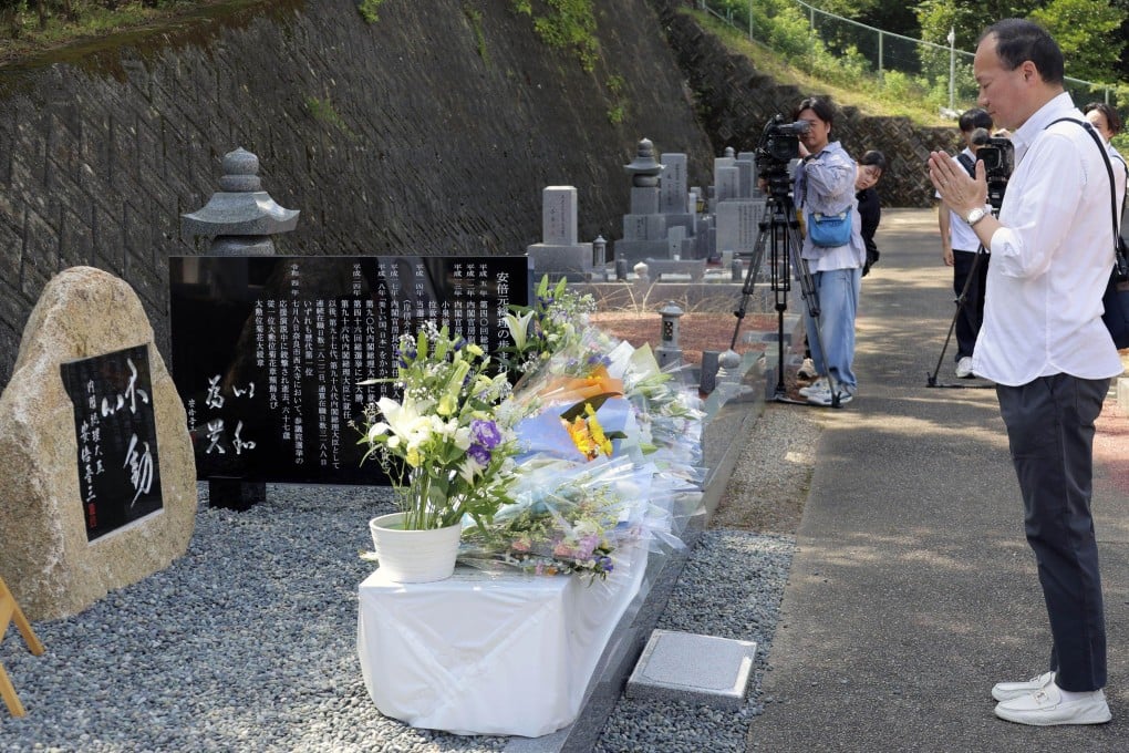 A man prays at a stone monument dedicated to former Japanese prime minister Shinzo Abe in a cemetery in Nara. Photo: Kyodo