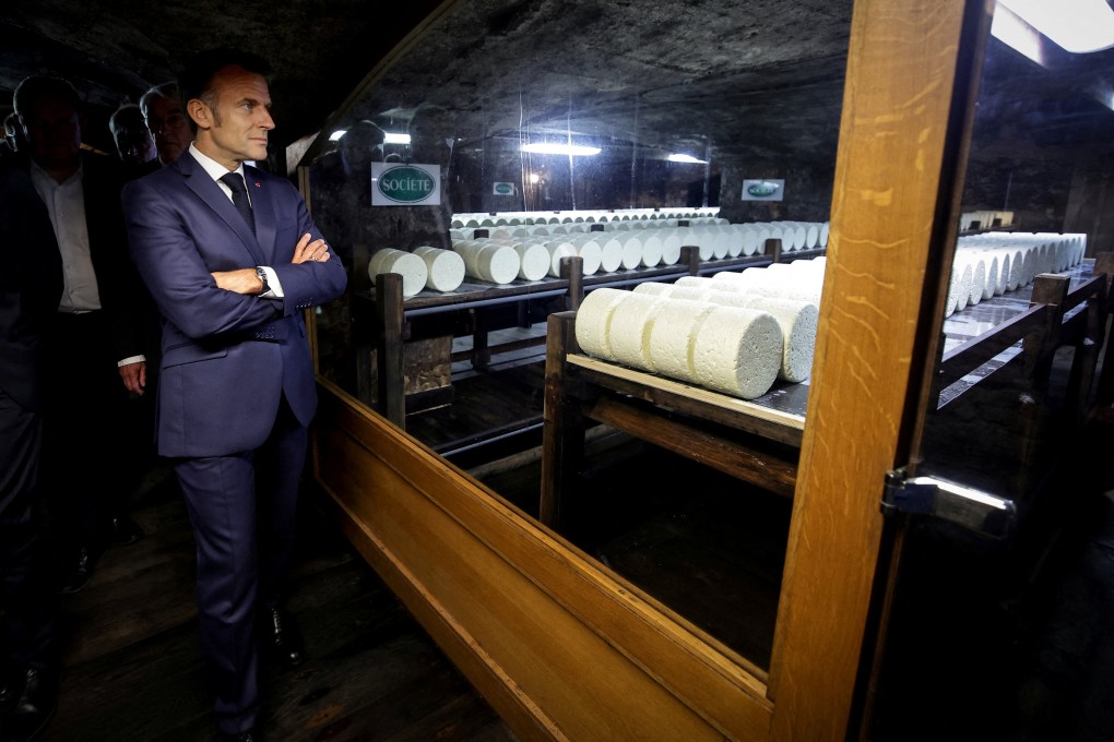 French President Emmanuel Macron visits the cellar of the Roquefort Societe cheese producer plant in Roquefort-sur-Soulzon, southern France on July 3. France sells US$409 million worth of dairy products to the US annually. Photo: Pool via Reuters
