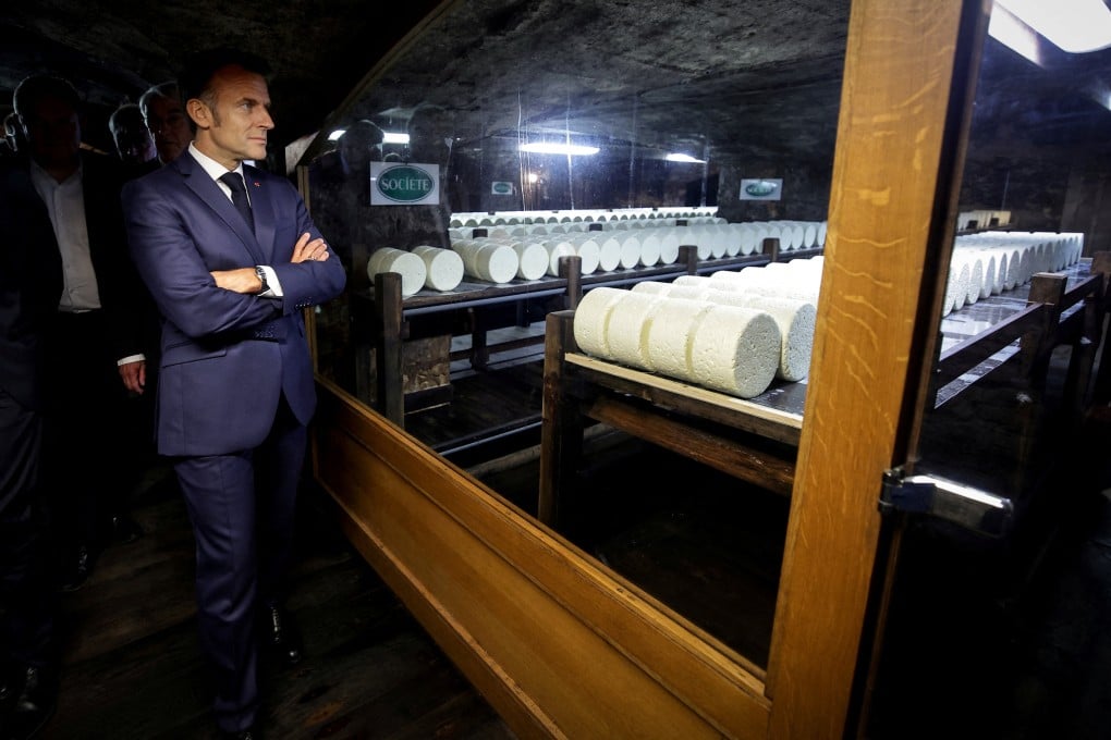 French President Emmanuel Macron visits the cellar of the Roquefort Societe cheese producer plant in Roquefort-sur-Soulzon, southern France on July 3. France sells US$409 million worth of dairy products to the US annually. Photo: Pool via Reuters