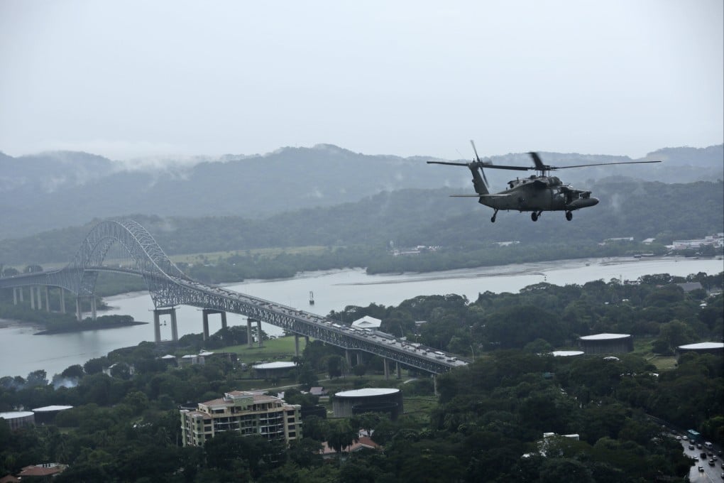 A US military Black Hawk helicopter flies over the Pacific side of the Panama Canal as it travels to the Darien province to provide a humanitarian assistance in Panama. Photo: AP