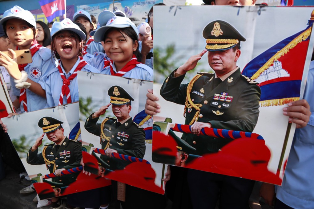 People hold portraits of Cambodian Prime Minister Hun Manet during a march in Phnom Penh on June 18. Cambodia will start conscripting civilians next year due to tensions with Thailand. Photo: EPA-EFE