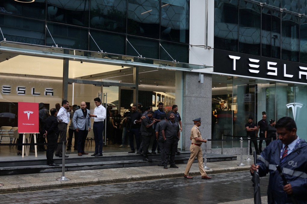 People are seen outside the Tesla showroom ahead of its opening in Mumbai, India, on Tuesday. Photo: Reuters
