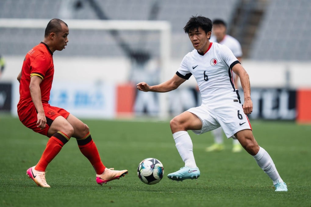 Hong Kong’s Tan Chun-lok (left) vies for possession with China goalscorer Huang Zhengyu. Photo: HKFA