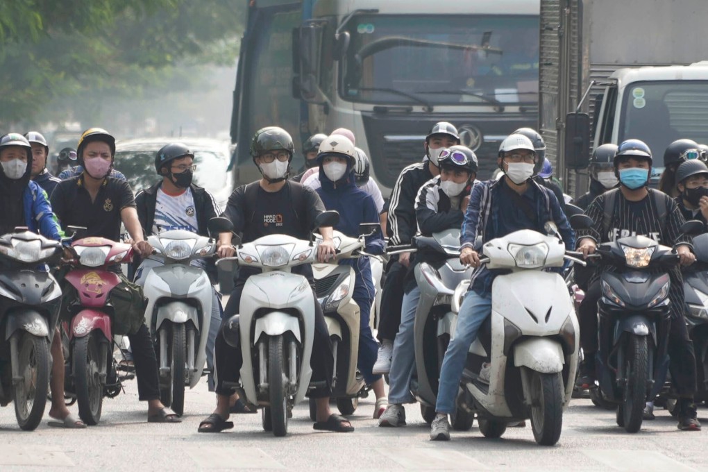 Motorcyclists wearing face masks wait at a traffic signal in Hanoi, Vietnam. Photo: AP