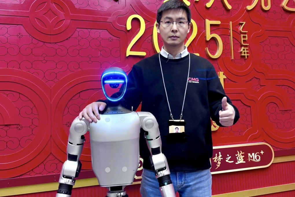 Unitree Robotics founder and CEO Wang Xingxing stands beside one of the firm’s G1 humanoid robots in January. Photo: Unitree