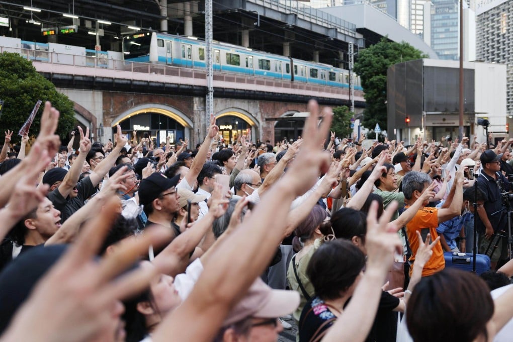 Voters listen to Sohei Kamiya, leader of the opposition Sanseito party in front of JR Shimbashi Station in Tokyo on July 3. Photo: Kyodo