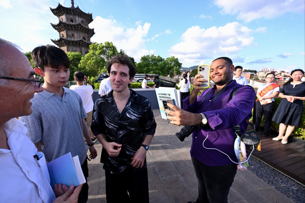 A tourist takes photos in Quanzhou, in southeast China’s Fujian province last month. Authorities say new visa-free measures are driving “large numbers” of foreign visitors to the country. Photo: Xinhua