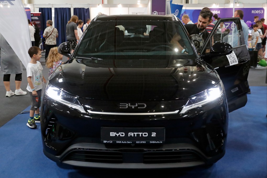 Visitors look at a BYD EV at the Bucharest Tech Expo in June. Photo: Xinhua