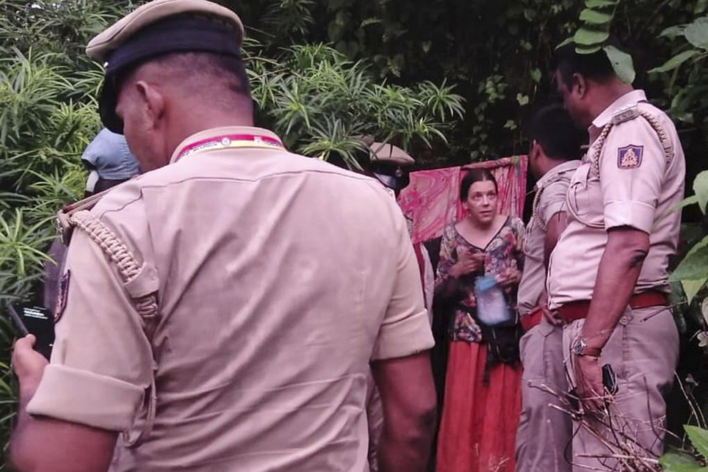 Indian policemen rescue Nina Kutina, , a Russian woman, from a cave in a forest area in the southern Indian state of Karnataka. Photo: AP