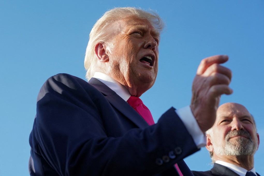 US President Donald Trump speaks with the media at Joint Base Andrews, Maryland, on Tuesday, as US Secretary of Commerce Howard Lutnick looks on. Photo: Reuters