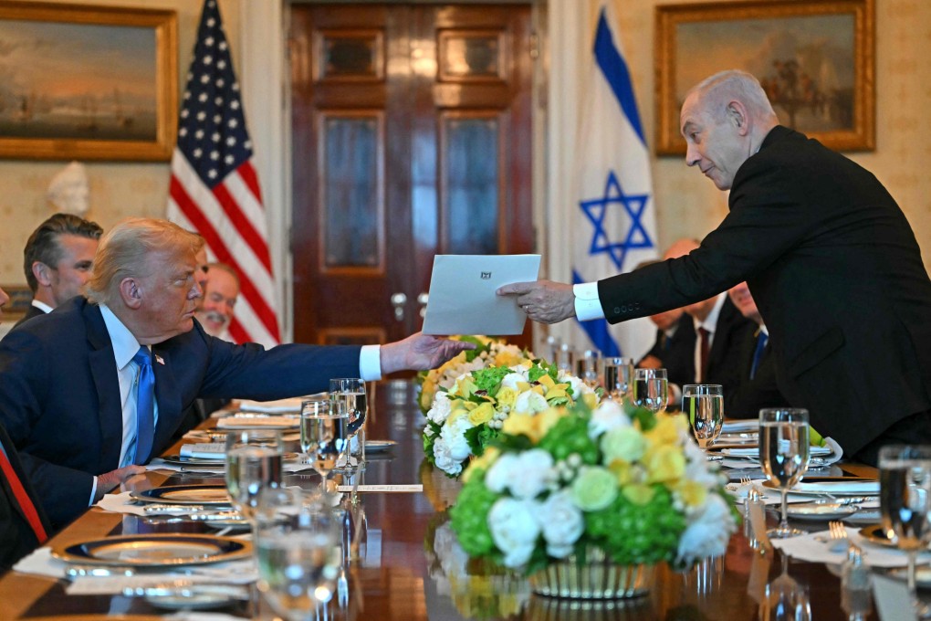 Israeli Prime Minister Benjamin Netanyahu (right) hands over a letter to US President Donald Trump at the White House on July 7. Photo: AFP