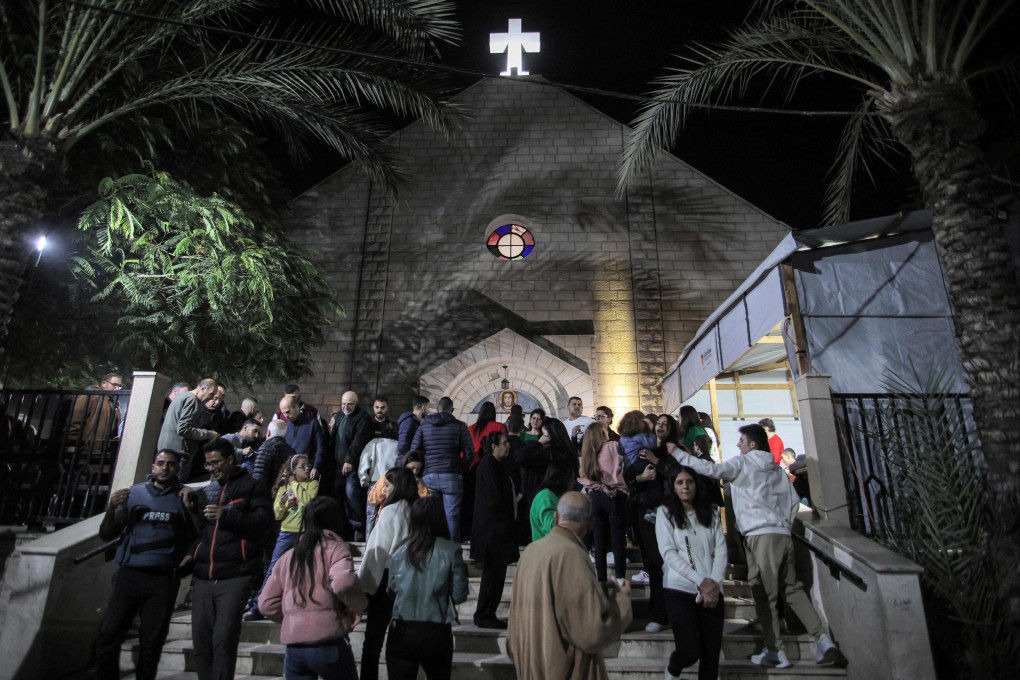 Worshippers walk outside after Christmas Eve mass at the Roman Catholic Church of the Holy Family in Gaza City. The Latin Patriarchate of Jerusalem said an Israeli strike killed two people at the church. Photo: AFP