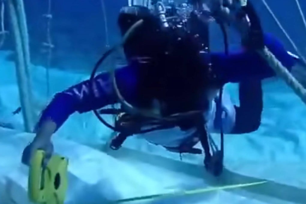 A diver inspects a parachute anchor near Thitu Island in the South China Sea, reportedly left behind by a Chinese vessel in June causing more than 11 million pesos (US$194,000) in damage to protected coral reefs, in this still from a social media video. Photo: Facebook/WPSTransparencyOffice