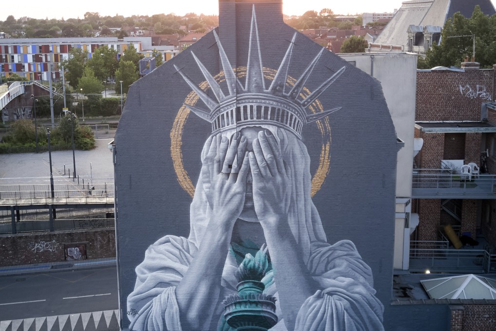 A mural by Dutch artist Judith de Leeuw shows the Statue of the Liberty covering her eyes with her hands, in northern France. Photo: Instagram/jdlstreetart/Judith de Leeuw/AP