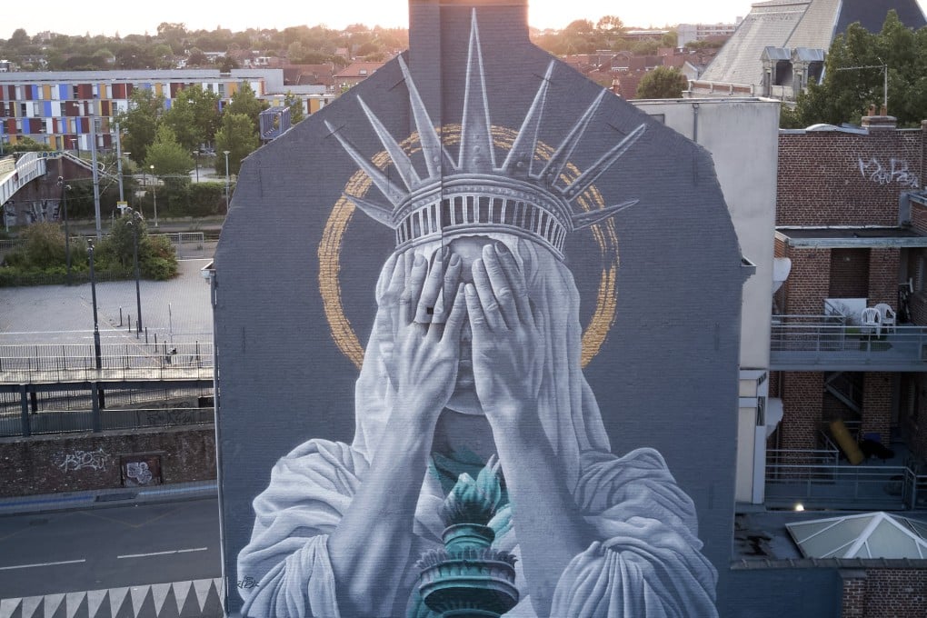 A mural by Dutch artist Judith de Leeuw shows the Statue of the Liberty covering her eyes with her hands, in northern France. Photo: Instagram/jdlstreetart/Judith de Leeuw/AP