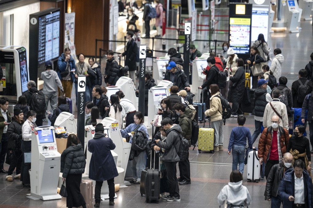 People wait to check-in at the departures hall of Haneda Airport in Tokyo. Photo: AFP