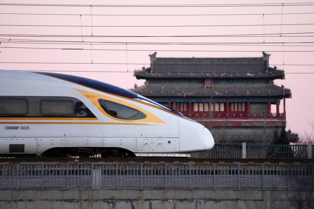 A bullet train passes by the Yongdingmen (Gate of Perpetual Peace) in Beijing. China’s high-speed railway lines span nearly 50,000km (31,000 miles). Photo: Xinhua