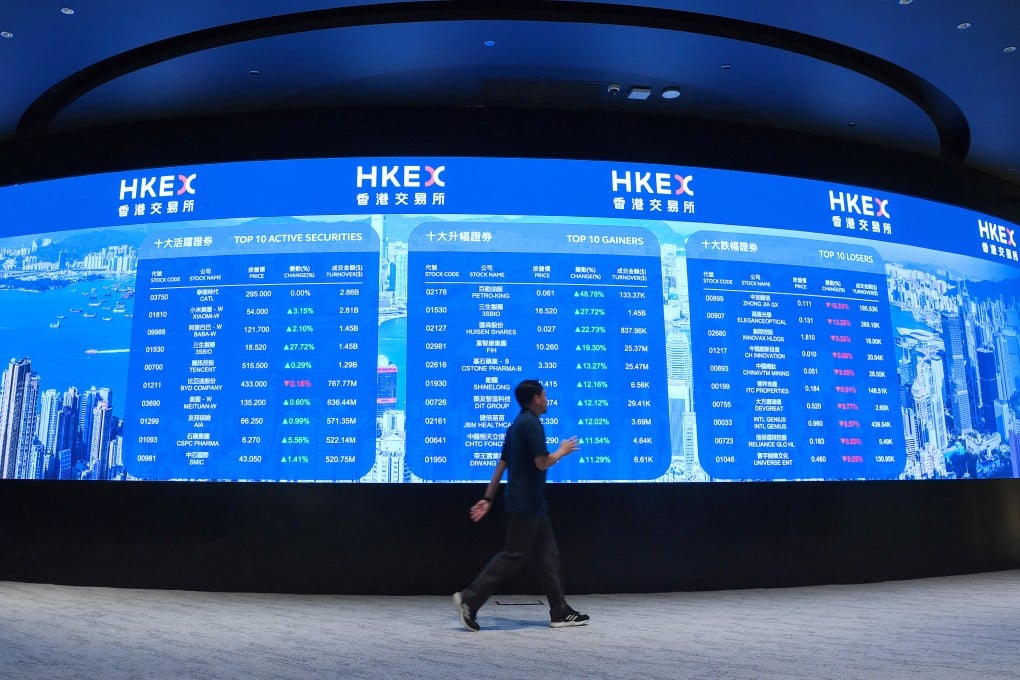 A man walks past an electronic display board at the Hong Kong stock exchange. Photo: Xinhua