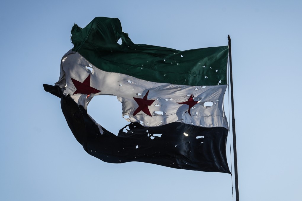 A tattered Syrian flag at the Syrian general staff headquarters after it was hit by Israeli airstrikes on Damascus. Photo: dpa