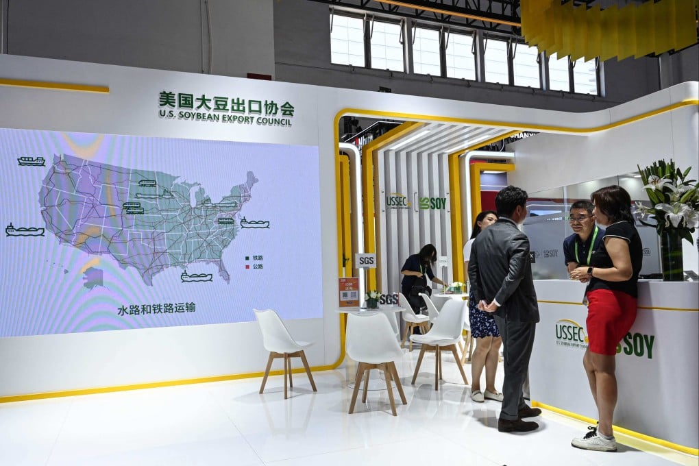 People talk at a US Soybean Export Council booth at the China International Supply Chain Expo in Beijing Wednesday. Photo: AFP