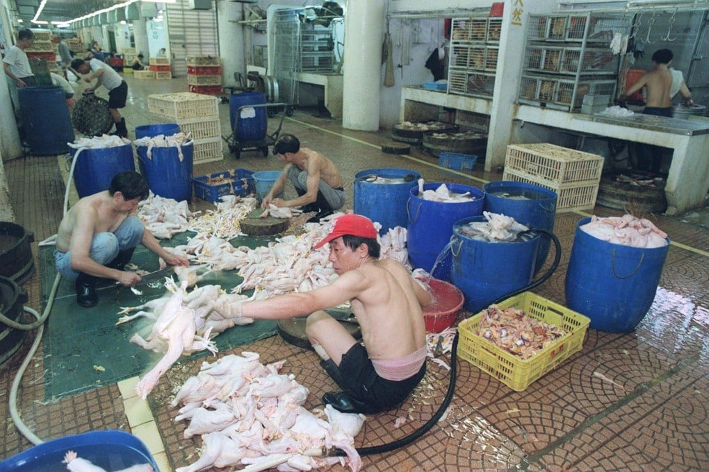 Workers prepare chickens before the market opens in August 1998. Photo: SCMP Archives
