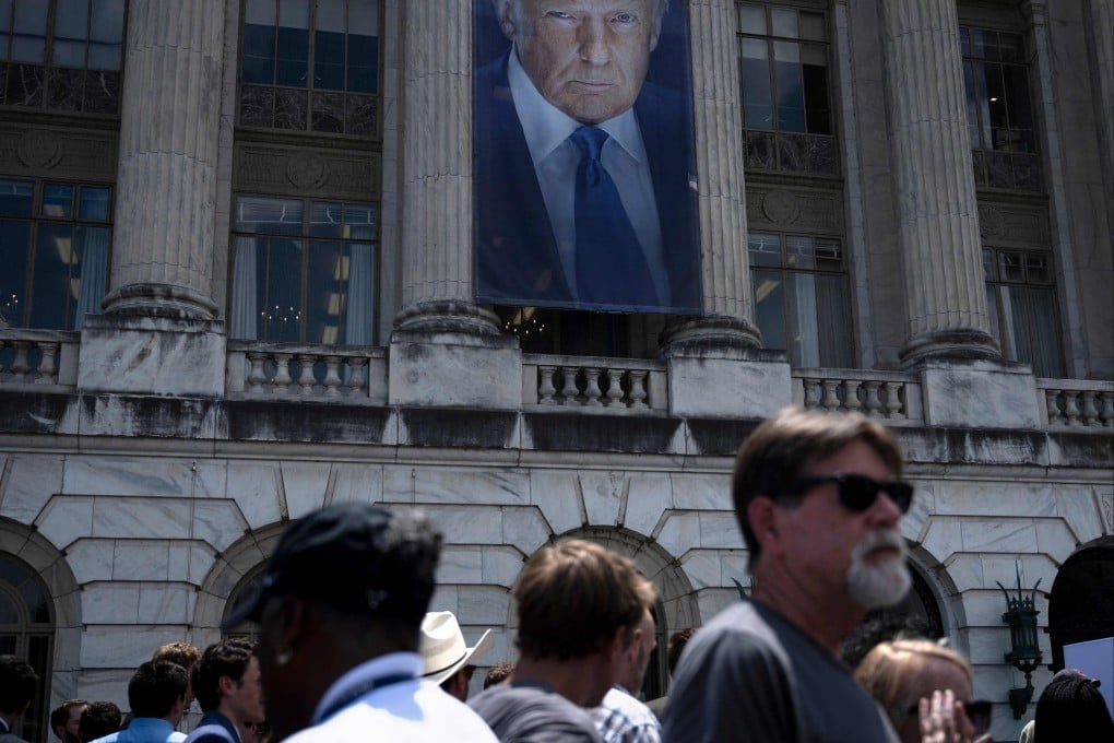 An image of US President Donald Trump hangs outside the USDA headquarters building in Washington, DC. Photo: AFP