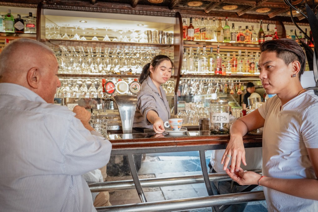 Lin Yichen (right), owner of Venice’s Bar Foscarini, and barista Sophia with cafe regular Claudio Gatta. Photo: Federico Sutera