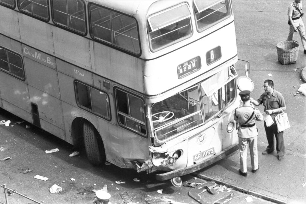 A China Motor Bus double-decker ploughed into a huge crowd in North Point, killing four people and injuring 46. Pictured here are policemen taking statements at the accident site. Photo: SCMP Archives