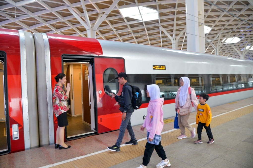 A crew member welcomes passengers boarding a high-speed train on the Jakarta-Bandung High-Speed Railway at Halim Station in Jakarta in November 2023. Photo: Xinhua