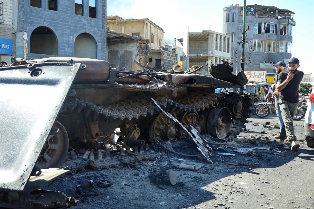 Syrian Druze fighters near a destroyed army military vehicle after Syrian forces pulled out of Sweida. Photo: AFP