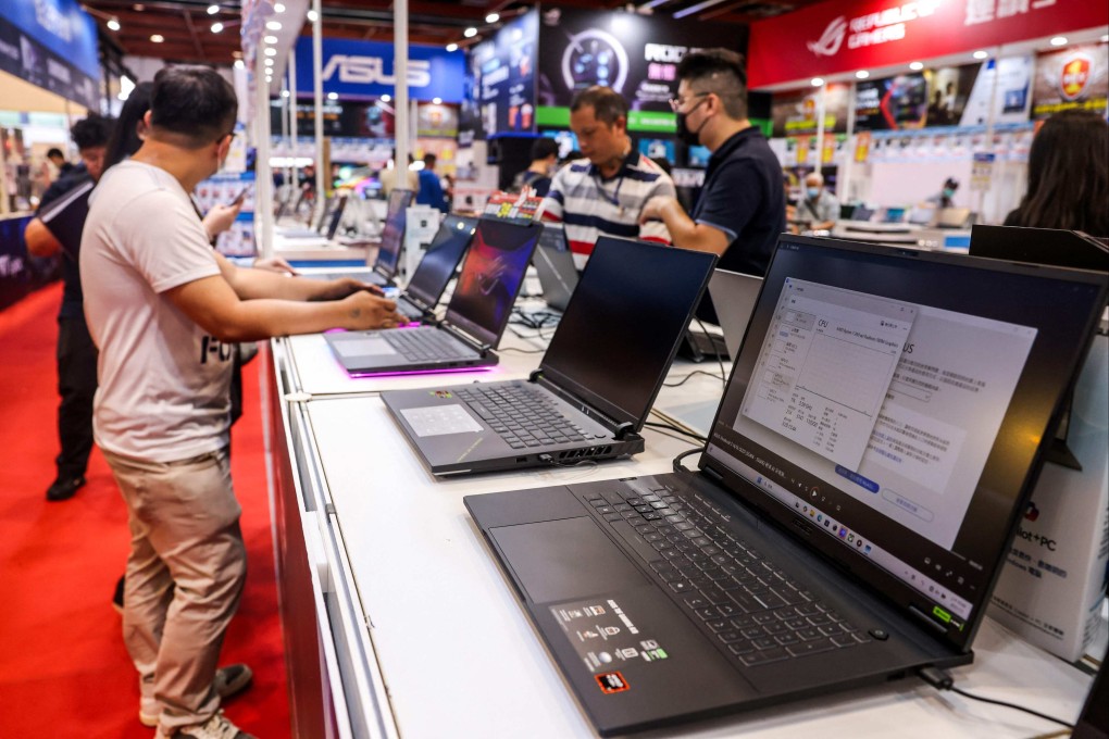 People look at laptops on display during a computer fair at Taipei World Trade Center in Taipei on July 4. Photo: AFP