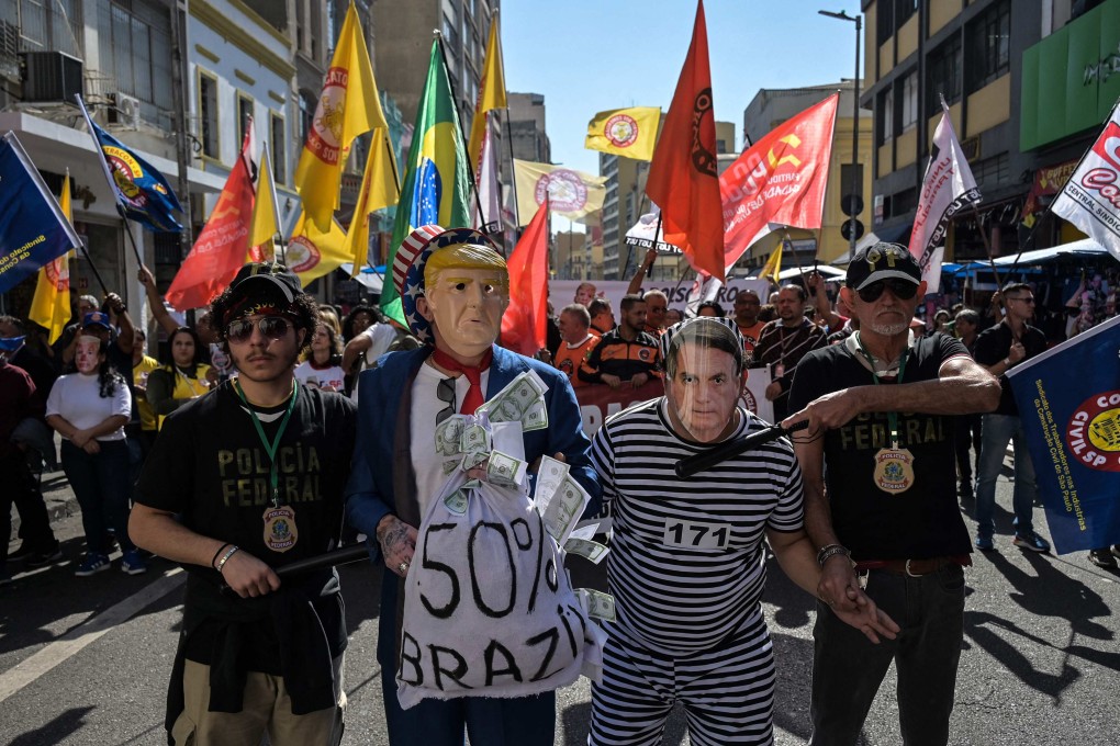 Protesters wearing masks depicting US President Donald Trump and former Brazilian leader Jair Bolsonaro take part in a rally in downtown Sao Paulo, Brazil, on July 18. Photo: AFP