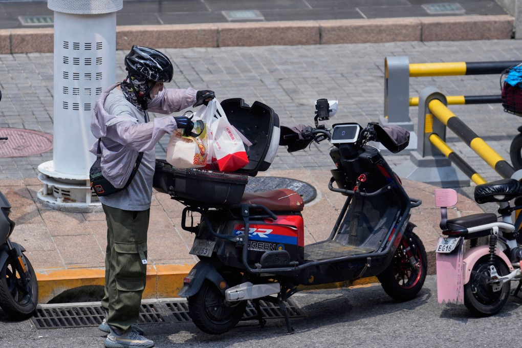 A a food delivery rider in Beijing. Photo: AP