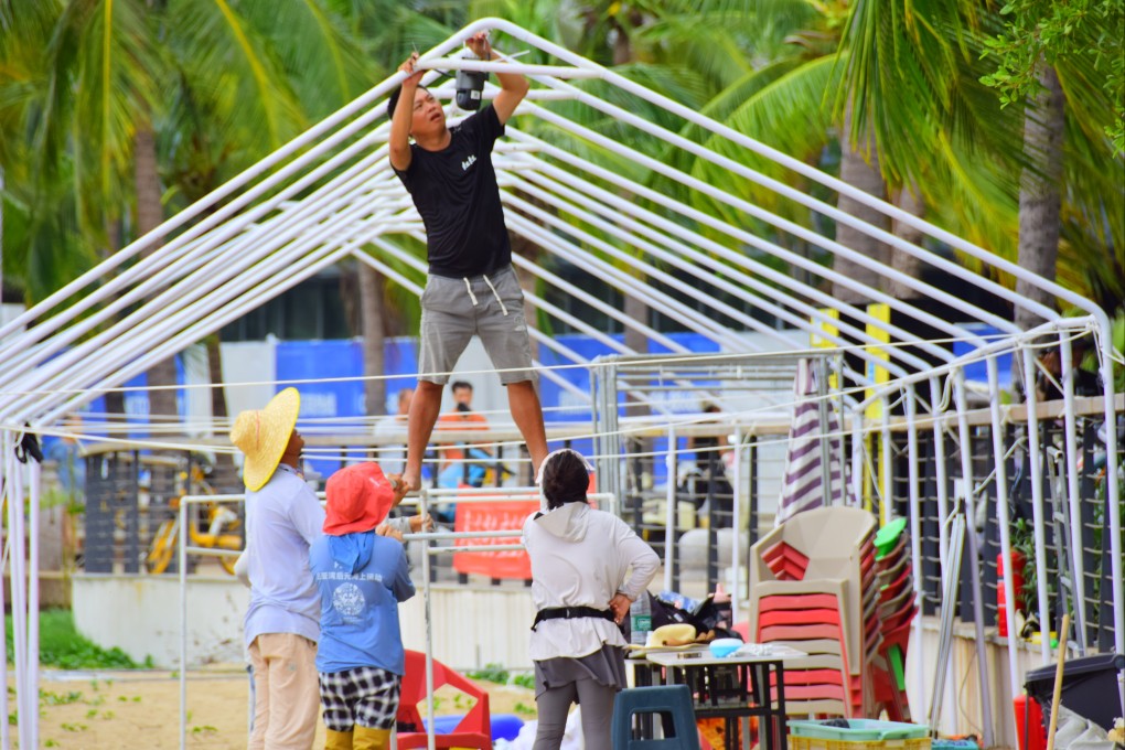 Workers take down a tent in Hainan ahead of the typhoon’s arrival. Photo: Getty Images