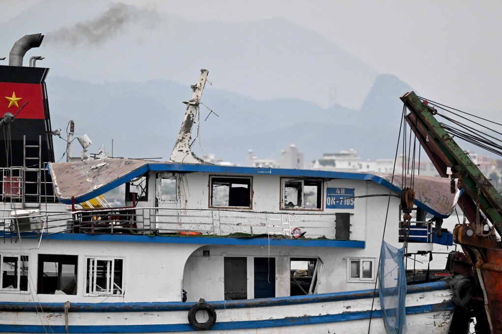 The tourist boat that capsized is towed back to the port in Ha Long Bay, Vietnam, on Sunday. Photo: AFP