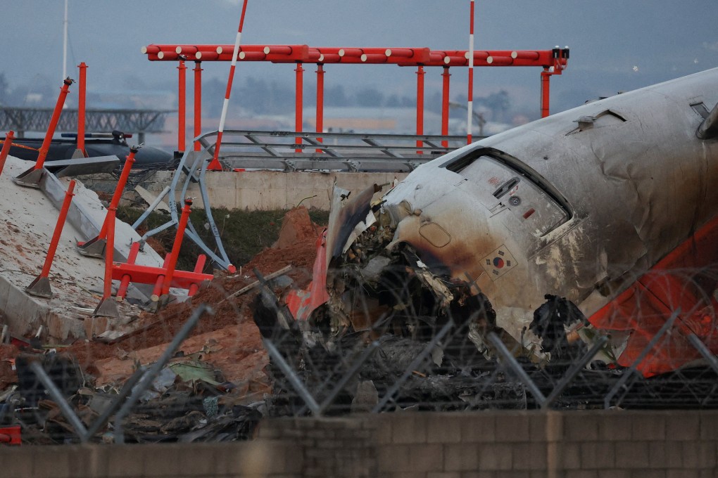The wreckage of the Jeju Air aircraft lies near the concrete structure it crashed into at Muan Airport, South Korea, on December 30 last year. Photo: Reuters