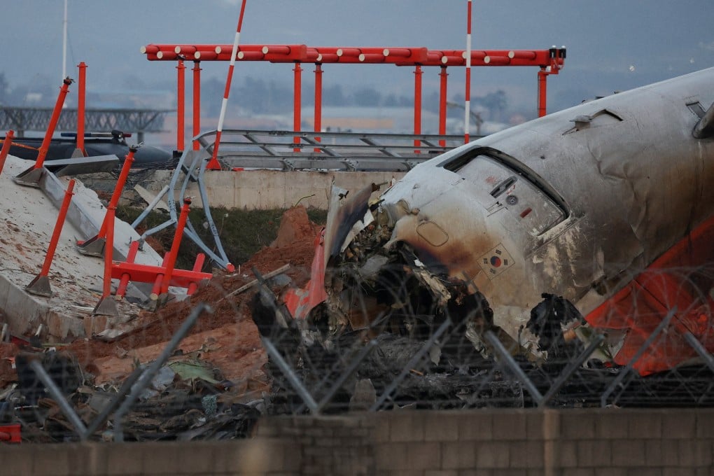 The wreckage of the Jeju Air aircraft lies near the concrete structure it crashed into at Muan Airport, South Korea, on December 30 last year. Photo: Reuters