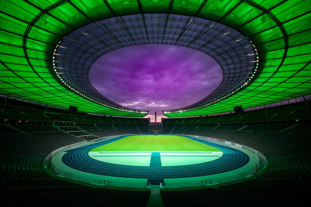 Berlin’s Olympiastadion is bathed in colour for its “Light Experience Tour”. Visitors can also explore the stadium on tours focusing on history, sports and architecture. Photo: Reiher & Seidel/Olympiastadion Berlin/dpa