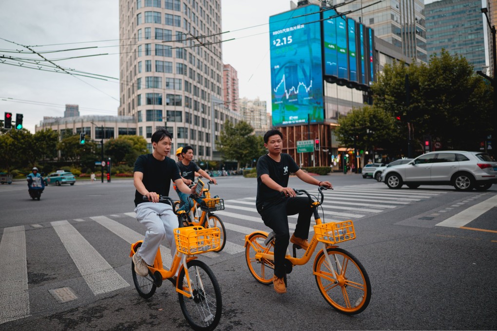 People bike through the streets of Shanghai. Photo: EPA-EFE