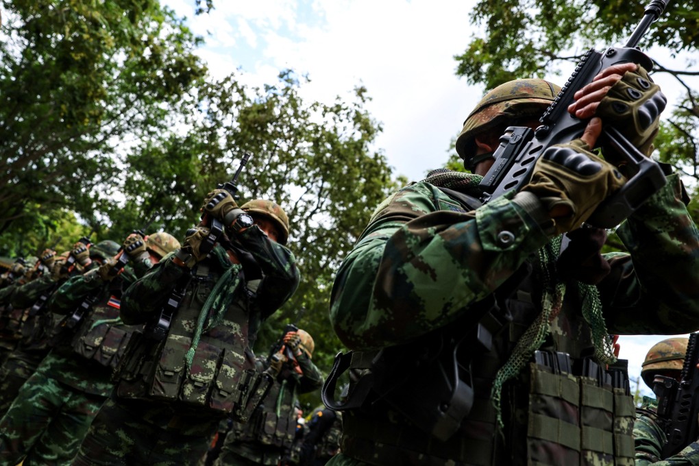 Thai soldiers salute with their weapons as then-prime minister Paetongtarn Shinawatra visits the Thailand-Cambodia border town of Aranyaprathet district on June 26. Photo: Reuters