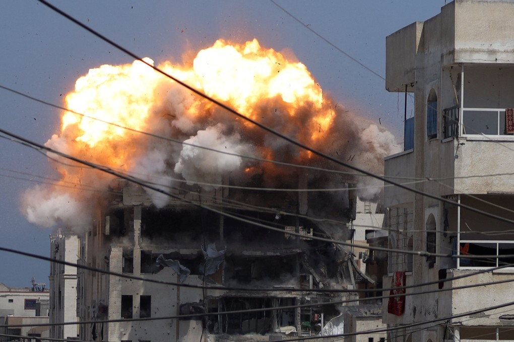 Smoke and flames rise from a residential building hit by an Israeli strike, in Gaza City on Monday. Photo: Reuters