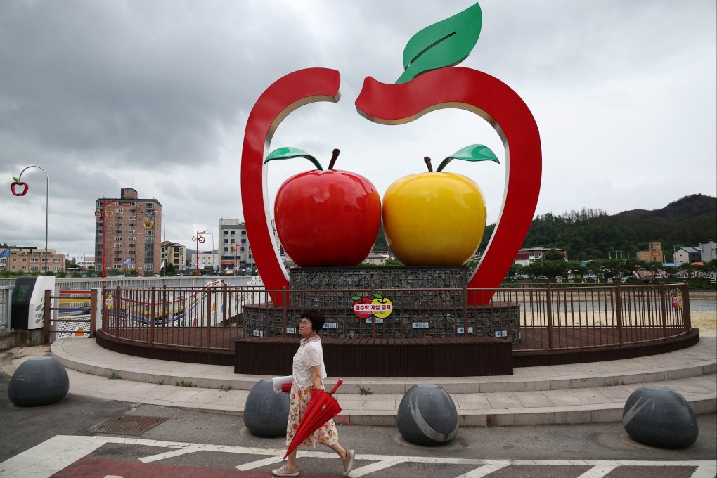 A woman walks past a sculpture featuring apples in Cheongsong, South Korea, on July 15. Photo: Reuters