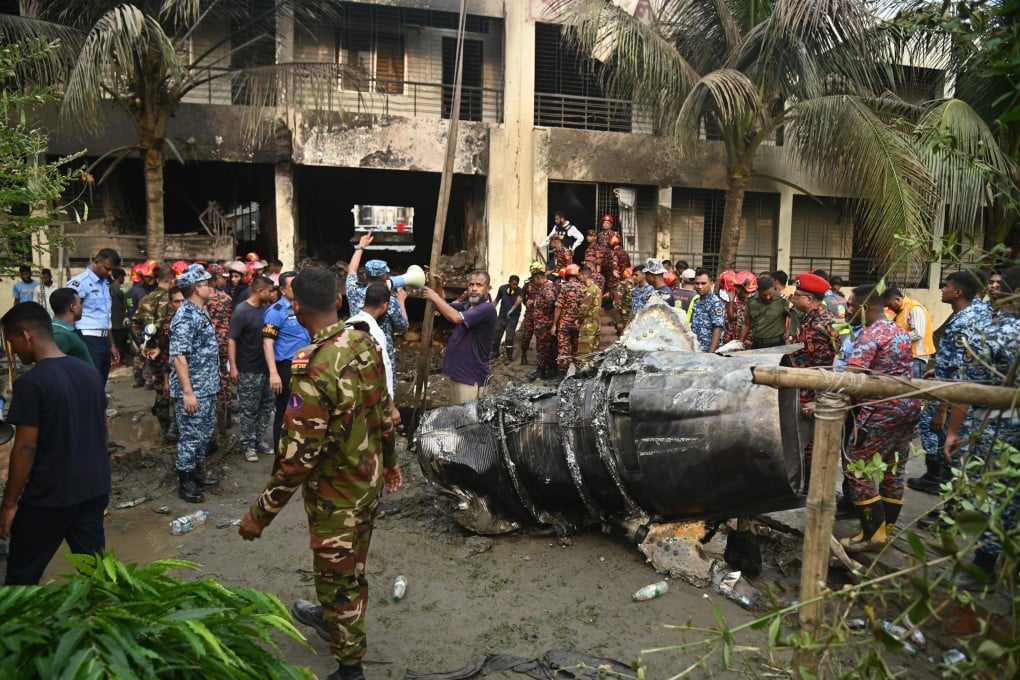 Firefighters work to remove the jet’s wreckage from a building in Dhaka, Bangladesh, on July 21. Photo: ZUMA Press Wire/dpa